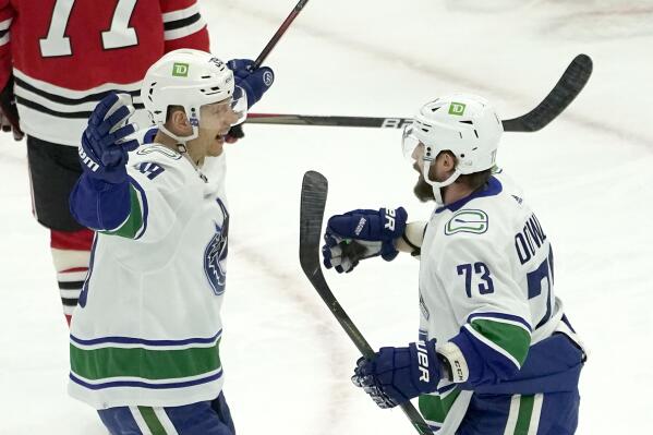 Vancouver Canucks' Alex Chiasson, left, celebrates his goal with Justin Dowling during the first period of an NHL hockey game against the Chicago Blackhawks, Monday, Jan. 31, 2022, in Chicago. (AP Photo/Charles Rex Arbogast)