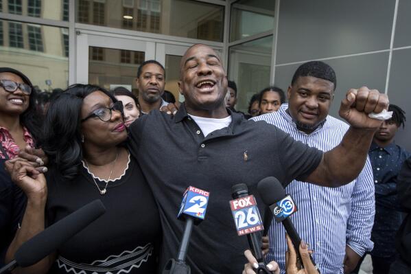 FILE - In this Nov. 26, 2019, file photo, Lydell Grant, center, his mother, Donna Poe, center-left, and brother Alonzo Poe, center-right, talk to reporters after Grant's release on bond in Houston after new evidence cleared him in a 2010 fatal stabbing. The Texas Court of Criminal Appeals has declared him innocent of his crime. (Jon Shapley/Houston Chronicle via AP, File)