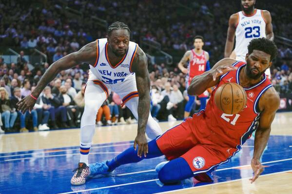Philadelphia 76ers' Joel Embiid (21) fights for control of the ball with New York Knicks' Julius Randle (30) during the first half of an NBA basketball game Tuesday, Oct. 26, 2021, in New York. (AP Photo/Frank Franklin II)