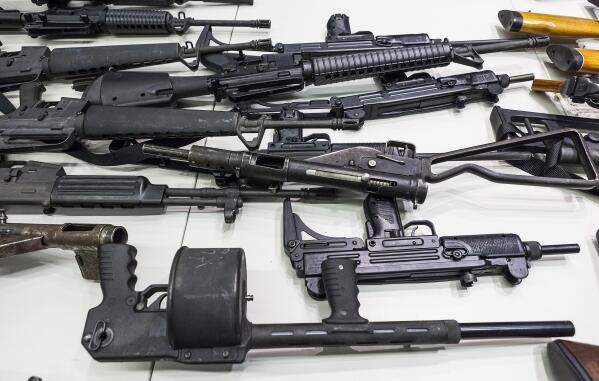 FILE - In this Dec. 27, 2012, file photo are some of the weapons that include handguns, rifles, shotguns and assault weapons, collected in a Los Angeles Gun Buyback event displayed during a news conference at the LAPD headquarters in Los Angeles. A federal judge has overturned California's three-decade-old ban on assault weapons, ruling that it violates the constitutional right to bear arms. U.S. District Judge Roger Benitez of San Diego ruled Friday, June 4, 2021, that the state's definition of illegal military-style rifles unlawfully deprives law-abiding Californians of weapons commonly allowed in most other states. (AP Photo/Damian Dovarganes, File)