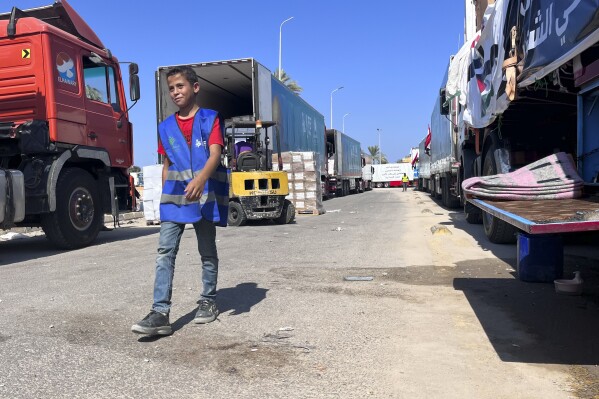 Humanitarian aid convoy for the Gaza Strip is parked in Arish, Egypt, Monday, Oct. 16, 2023. Hundreds of Palestinians in the Gaza Strip have fled their homes ahead of an expected Israeli ground invasion aimed at destroying Hamas after its fighters rampaged through southern Israel. (AP Photo/Omar Aziz)