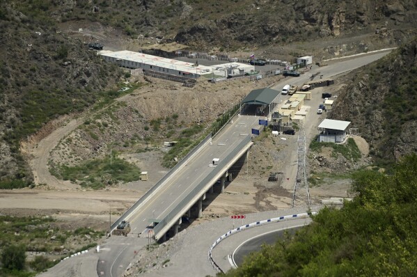 A bridge and a checkpoint are seen on a road towards the separatist region of Nagorno-Karabakh, in Armenia, Friday, July 28, 2023. The former chief prosecutor of the International Criminal Court warned that Azerbaijan is preparing genocide against ethnic Armenians in its Nagorno-Karabakh region and called for the UN Security Council to bring the matter before the ICC. A report by Luis Moreno Ocampo issued Tuesday, Aug. 8 said Azerbaijan's blockade of the only road leading from Armenia to Nagorno-Karabakh seriously impedes food, medical supplies and other essentials to the region of about 120,000 people. (Hayk Manukyan/PHOTOLURE via AP)