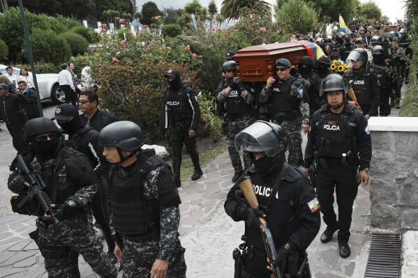 Police escort and carry the remains of slain presidential candidate Fernando Villavicencio to a chapel before his burial Camposanto Monteolivo cemetery in Quito, Ecuador, Friday, Aug. 11, 2023. The 59-year-old was fatally shot at a political rally on Aug. 9 in Quito. (AP Photo/Dolores Ochoa)