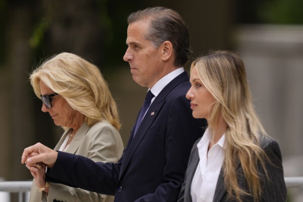 Hunter Biden, center, President Joe Biden's son, accompanied by his mother, first lady Jill Biden, left, and his wife, Melissa Cohen Biden, right, walking out of federal court after hearing the verdict, Tuesday, June 11, 2024, in Wilmington, Del. Hunter Biden has been convicted of all 3 felony charges in the federal gun trial. (AP Photo/Matt Rourke)