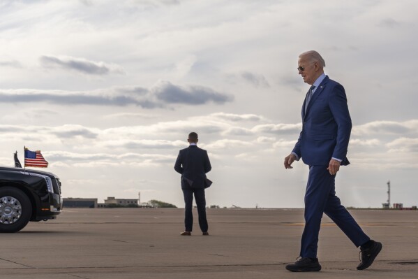 President Joe Biden walks to his motorcade after departing Air Force One, Wednesday March 20, 2024, on arrival at Dallas-Fort Worth International Airport, in Dallas. (AP Photo/Jacquelyn Martin)