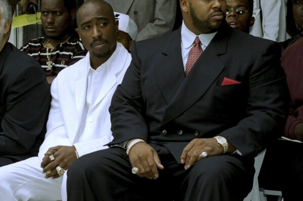 FILE - Rapper Tupac Shakur, left, and Death Row Records Chairman Marion 