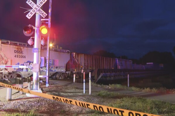 In this image made from video, a train sits idle on tracks after striking multiple pedestrians Sunday evening, May 18, 2025, in Fremont, Ohio. (WTVG/13 Action News via AP)