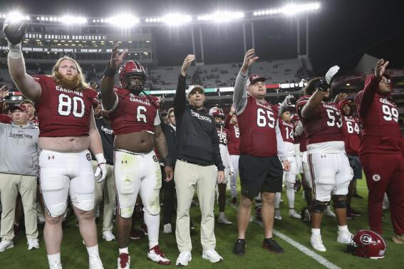 South Carolina head coach Shane Beamer, center, participates in a postgame tradition after an NCAA college football game against Missouri, Saturday, Oct. 29, 2022, in Columbia, S.C. (AP Photo/Artie Walker Jr.)