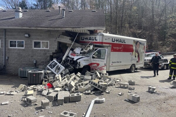 In this photo provided by WCHS-TV, a rental truck is shown after it drove into the side of an animal shelter Wednesday, March 27, 2024, in Charleston, W.Va (Matt Durrett/WCHS-TV via AP)