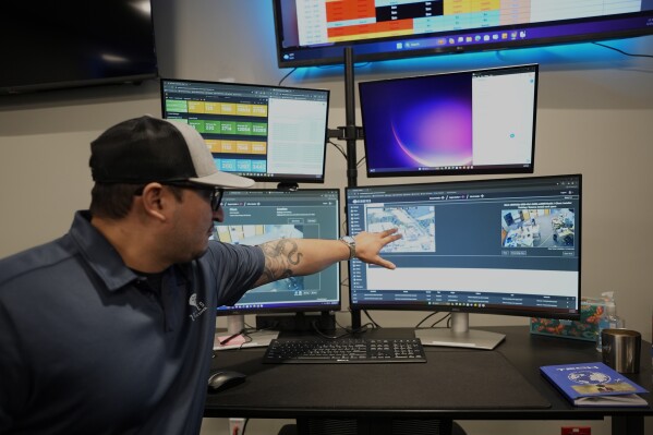 ZeroEyes analyst Mario Hernandez demonstrates the use of artificial intelligence with surveillance cameras to identify visible guns at the company's operations center, Friday, May 10, 2024, in Conshohocken, Pa. (AP Photo/Matt Slocum)