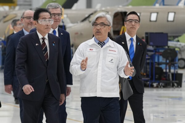 Japanese Prime Minister Fumio Kishida, left, and North Carolina Gov. Roy Cooper, back left, tour the assembly building during a visit to the Honda Aircraft facility in Greensboro, N.C., Friday, April 12, 2024. (AP Photo/Chuck Burton)