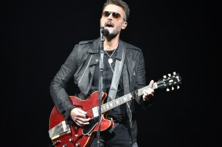 FILE - In this March 23, 2019 file photo, Eric Church performs during his Double Down tour in Rosemont, Ill. The country singer sent a message to fans in a new video that offers his belief in American resolve to overcome the pandemic. He is teasing new music, including a song called “Through My Ray Bans” from a forthcoming album.  (Photo by Rob Grabowski/Invision/AP, File)