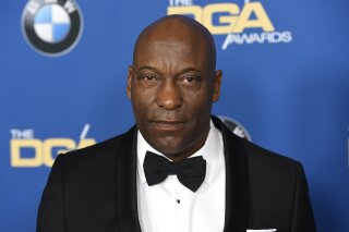 
              FILE - In this Feb. 3, 2018 file photo, John Singleton arrives at the 70th annual Directors Guild of America Awards in Beverly Hills, Calif. The "Boyz N the Hood" director suffered a stroke last week and remains hospitalized, according to a statement from his family on Saturday, April 20, 2019. (Photo by Chris Pizzello/Invision/AP)
            