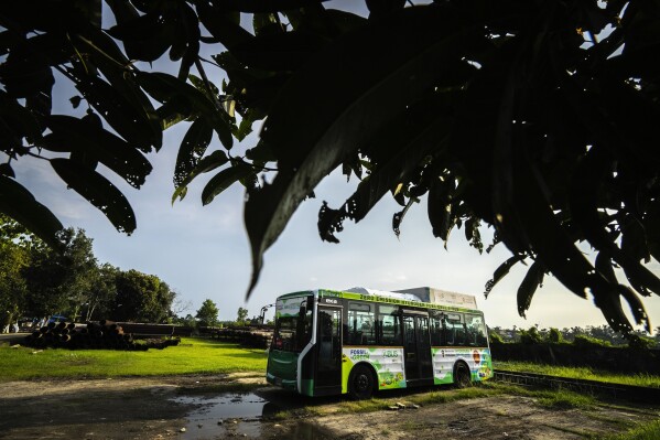 A bus that runs on green hydrogen sits at a hydrogen plant at Oil India Limited in Jorhat, India, Thursday, Aug. 17, 2023. Green hydrogen is being touted around the world as a clean energy solution to take the carbon out of high-emitting sectors like transport and industrial manufacturing.(AP Photo/Anupam Nath)