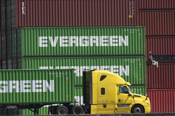 Containers are stacked at the Port of Los Angeles Wednesday, April 2, 2025, in Los Angeles. (AP Photo/Damian Dovarganes)