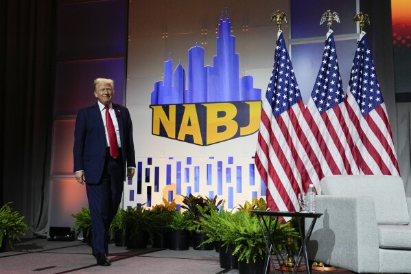 Republican presidential candidate former President Donald Trump walks on stage at the National Association of Black Journalists, NABJ, convention, Wednesday, July 31, 2024, in Chicago. (AP Photo/Charles Rex Arbogast)