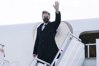 Secretary of State Antony Blinken waves as he departs the Geneva Airport, Friday, Jan. 21, 2022, in Geneva, Switzerland. (AP Photo/Alex Brandon, Pool)