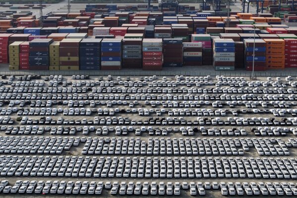 New Volvo vehicles parked near containers as waiting for shipment at the Yangtze port, in Nanjing city in east China's Jiangsu province, Wednesday, April 9, 2025. (Chinatopix Via AP)