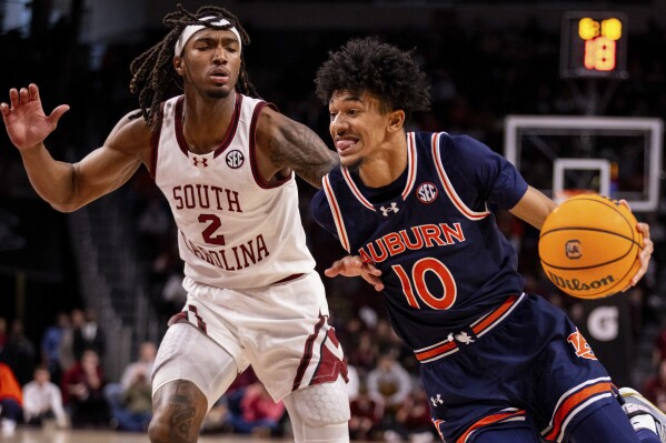 Auburn guard Chad Baker-Mazara (10) drives past South Carolina guard Zachary Davis (2) during the first half of an NCAA college basketball game on Saturday, Jan. 11, 2025, in Columbia, S.C. (AP Photo/Scott Kinser)
