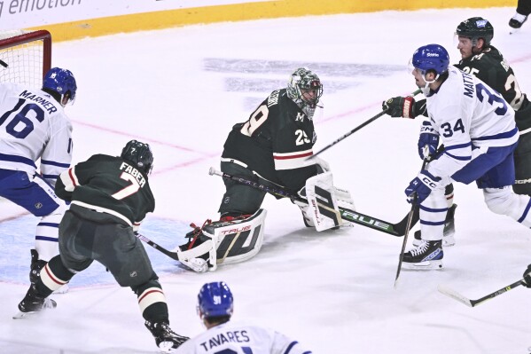 Toronto's Auston Matthews, right, scores at Minnesota's goalkeeper Marc-Andre Fleury during the NHL Global Series Sweden ice hockey match between Toronto Maple Leafs and Minnesota Wild at Avicii Arena in Stockholm, Sweden, Sunday, Nov. 19, 2023.(Claudio Bresciani/TT via AP)