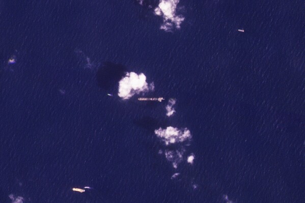 This satellite image from Planet Labs PBC shows the USNS Roy P. Benavidez, center, in the Mediterranean Sea off the coast of the Gaza Strip on Monday, April 29, 2024. A U.S. Navy ship participating in a U.S.-led effort to bring more aid to the blockaded Gaza Strip offshore the enclave, and is slowly building a floating platform for the operation, satellite images analyzed by The Associated Press showed Monday.  (Planet Labs PBC via AP)