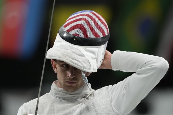 United State's Nick Itkin wears his mask as he competes with Italy's Tommaso Marini in the men's team foil semifinal match during the 2024 Summer Olympics at the Grand Palais, Sunday, Aug. 4, 2024, in Paris, France. (AP Photo/Andrew Medichini)