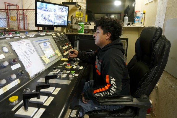 A worker sits in a mining winch operations room at the Energy Fuels Inc. uranium Pinyon Plain Mine Wednesday, Jan. 31, 2024, near Tusayan, Ariz. (AP Photo/Ross D. Franklin)