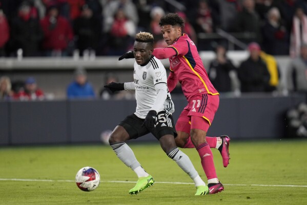 FILE - San Jose Earthquakes' Ousseni Bouda (25) and St. Louis City's Nicholas Gioacchini (11) vie for the ball during the second half of an MLS soccer match Saturday, March 18, 2023, in St. Louis. Bouda arrived at the Right to Dream academy not knowing the language and with no guarantees he’d be accepted into the residential development program and school. But the youngster showed talent and won a spot. Now, Right to Dream is coming to the United States as the academy under San Diego FC, which will join MLS as the league’s 30th team in 2025. (AP Photo/Jeff Roberson, File)