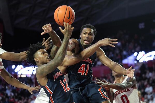 Auburn guard Zep Jasper (12) and Chris Moore (41) battle for a rebound during the second half of an NCAA college basketball game against Georgia Wednesday, Jan. 4, 2023, in Athens, Ga. (AP Photo/John Bazemore)
