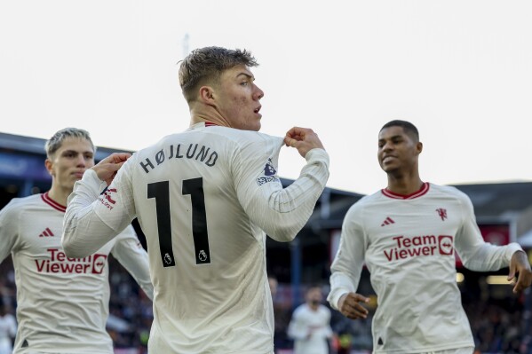 Manchester United's Rasmus Hojlund celebrates after scoring his side's opening goal during the English Premier League soccer match between Luton Town and Manchester United at Kenilworth Road, in Luton, England, Sunday, Feb. 18, 2024. (AP Photo/Ian Walton)