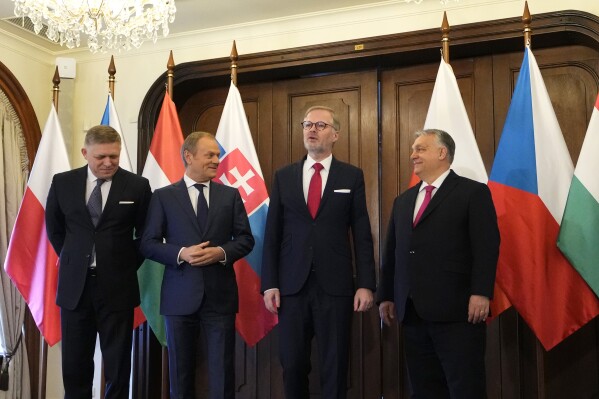 From left, Prime Minister of Slovakia Robert Fico, Prime Minsiter of Poland Donald Tusk, Prime Minister of Czech Republic Petr Fiala, and Prime Minister of Hungary Viktor Orban pose for a photo during their V4 meeting in Prague, Czech Republic, Tuesday, Feb. 27, 2024. (AP Photo/Petr David Josek)