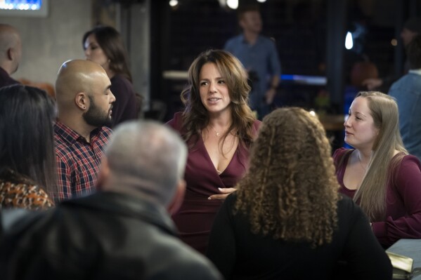 Professional matchmaker Michal Naisteter speaks with attendees at a Philadelphia Distilling Daters Mixer Hosted by Date Him Philly in Philadelphia, Tuesday, Nov. 14, 2023. Some of the most populous urban areas in the United States have an imbalanced sex ratio. Many of the largest counties along the Eastern Seaboard and in the Deep South skew female, while the largest urban counties in the West tilt male, according to data released this fall from the 2022 American Community Survey (AP Photo/Matt Rourke)