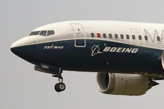 FILE - A Boeing 737 Max jet prepares to land at Boeing Field following a test flight in Seattle, Sept. 30, 2020. Boeing said Tuesday, Jan. 10, 2023, that it took more than 200 net orders for passenger airplanes in December and finished 2022 with its best year since 2018, which was before two deadly crashes involving its 737 Max jet and a pandemic that choked off demand for new planes. (AP Photo/Elaine Thompson, File)