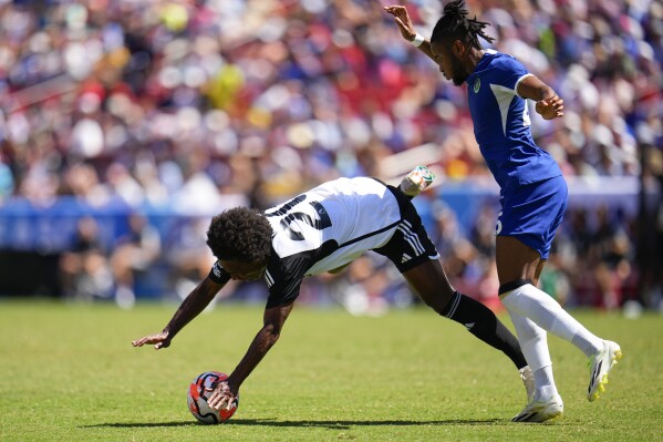 Fulham's William, left, is fouled by Chelsea's Christopher Nkunku during a Premier League Summer Series soccer match, Sunday, July 30, 2023, in Landover, Md. (AP Photo/Julio Cortez)