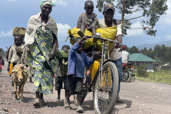 FILE - Residents flee fighting between M23 rebels and Congolese forces near Kibumba, some 20 kms ( 12 miles) North of Goma, Democratic Republic of Congo, on Oct. 28, 2022. The United Nations is warning that violence in eastern Congo has escalated significantly. A U.N. spokesperson says more than 600 people have been killed and 345,000 displaced in Ituri province alone so far this year. (AP Photo/Justin Kabumba, File)