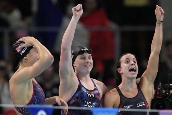 United States' Gretchen Walsh, from left, Lilly King and Regan Smith celebrate winning the gold medal in the women's 4x100-meter medley relay final at the Summer Olympics in Nanterre, France, Sunday, Aug. 4, 2024.(AP Photo/Brynn Anderson)