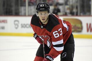 FILE - New Jersey Devils left wing Jesper Bratt (63) looks on during the second period of an NHL hockey game against the Pittsburgh Penguins in Newark, N.J., on Dec. 19, 2021. The Devils avoided arbitration with Bratt, signing the up-and-coming Swedish forward to a one-year, $5.45 million contract. General manager Tom Fitzgerald announced the signing Wednesday, Aug. 3, 2022, before the two sides were schedule to go to arbitration. (AP Photo/Bill Kostroun, File)