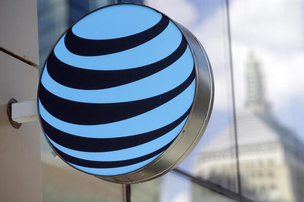 FILE - In this July 29, 2019 photo an AT&T logo sits above an entrance to a building, in Boston.  U.S. antitrust regulators have cleared the $43 billion combination of Discovery and AT&T’s WarnerMedia, according to corporate securities filings, Wednesday, Feb. 9, 2022. Discovery says it and AT&T have not gotten objections from the Department of Justice or the Federal Trade Commission.  (AP Photo/Steven Senne, File)
