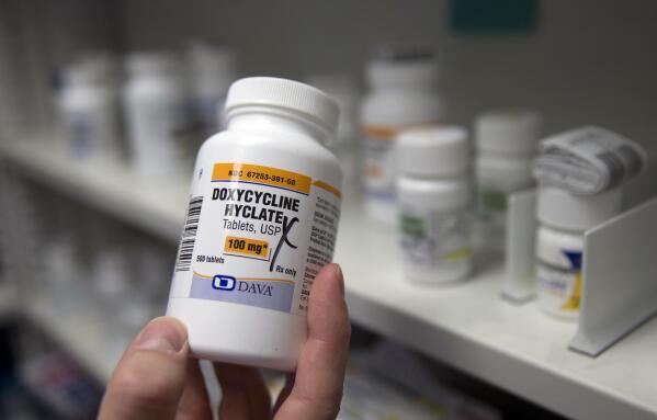FILE - A pharmacist holds a bottle of the antibiotic doxycycline hyclate in Sacramento, Calif., July 8, 2016. On Tuesday, April 11, 2023, the Centers for Disease Control and Prevention released data about some of the most common infectious diseases in the U.S. The numbers show how chlamydia, gonorrhea and syphilis infections have been accelerating across the country. Meanwhile, the CDC is considering recommending the antibiotic doxycycline to be used after sex to prevent those infections. (AP Photo/Rich Pedroncelli, File)