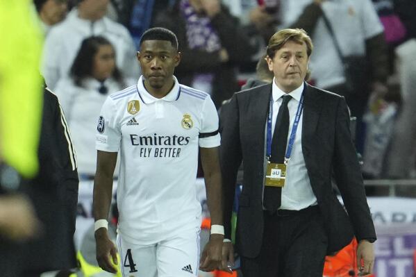 Real Madrid's David Alaba walks off the pitch while he is substituted by Real Madrid's Nacho after being injured during the Champions League, round of 16, first leg soccer match between Liverpool and Real Madrid at the Anfield stadium in Liverpool, England, Tuesday, Feb. 21, 2023. (AP Photo/Jon Super)