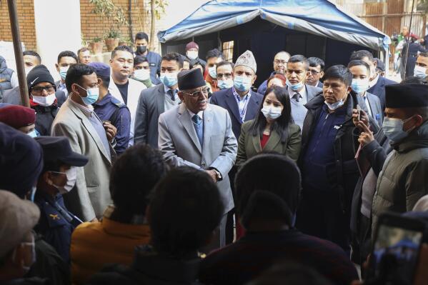 In this handout photo provided by the Nepal Prime Minister Secretariat, Prime minister Pushpa Kamal Dahal Prachanda, center, speaks to the officials during his visit to Teaching Hospital in Kathmandu, Nepal, Thursday, Jan. 19, 2023. Prachanda on Thursday condoled with the bereaved families and asked hospital authorities to expedite the autopsies of victims of Sunday's Yeti Airlines plane crash that killed all 72 people on board. (Nepal Prime Minister Secretariat via AP)