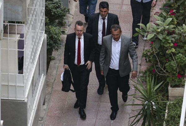 
              U.S. Pastor Andrew Brunson, front left, arrives at home after his release, following his trial in Izmir, Turkey, Friday, Oct. 12, 2018, A Turkish court on Friday convicted an American pastor of terror charges but released him from house arrest and allowed him to leave Turkey, in a move that is likely to ease tensions between Turkey and the United States. (AP Photo/Emre Tazegul)
            