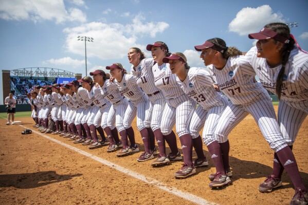 The Texas A&M softball team sings the Aggie War Hymn after the win during the NCAA Division I regional final softball game against Texas State on Sunday, May 19, 2024, in College Station, Texas. (Meredith Seaver/College Station Eagle via AP)