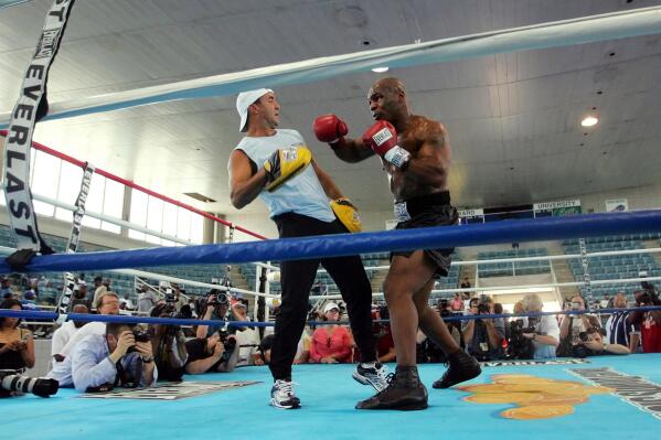 FILE - Former Heavyweight Champion Mike Tyson, right, spars with his trainer Jeff Fenech in the ring at Burr Gymnasium on the Campus of Howard University in Washington on June 7, 2005 in preparation for June 11 fight against Kevin McBride. Australian Jeff Fenech is finally joining an elite group of boxers to have won world titles in four weight divisions, more than 30 years after the fact. (AP Photo/Pablo Martinez Monsivais, File)