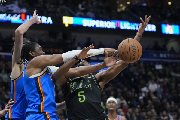 Oklahoma City Thunder forward Jalen Williams strips the ball from New Orleans Pelicans forward Herbert Jones (5) in the first half of Game 4 of an NBA basketball first-round playoff series in New Orleans, Monday, April 29, 2024. (AP Photo/Gerald Herbert)