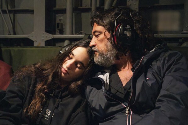 Gal Tarchansky, who was released last night, sits with her father in an IDF helicopter en route from Hatzerim Air Base to Schneider Hospital, in Israel, Thursday, November 30, 2023. (GPO/Handout via AP)