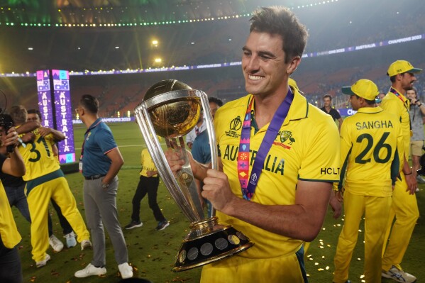 Australia's captain Pat Cummins poses for a photograph with the trophy after Australia won the ICC Men's Cricket World Cup final match against India in Ahmedabad, India, Sunday, Nov. 19, 2023. (AP Photo/Rafiq Maqbool)