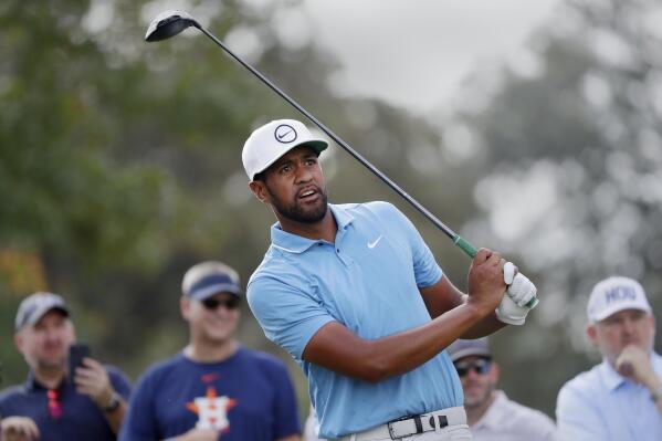 CORRECTS TO 12TH HOLE, NOT 11TH HOLE - Tony Finau watches his tee shot on the 12th hole during the second round of the Houston Open golf tournament, Friday, Nov. 11, 2022, in Houston. (AP Photo/Michael Wyke)