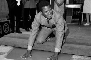 REMOVES REFERENCE TO THE BAHAMAS - FILE -  Sidney Poitier, star of "To Sir With Love," places his hands in wet cement at Grauman's Chinese Theater in Los Angeles on  June 23, 1967.  Poitier, the groundbreaking actor and enduring inspiration who transformed how Black people were portrayed on screen, became the first Black actor to win an Academy Award for best lead performance and the first to be a top box-office draw, died Thursday, Jan. 6, 2022. He was 94. (AP Photo/File)