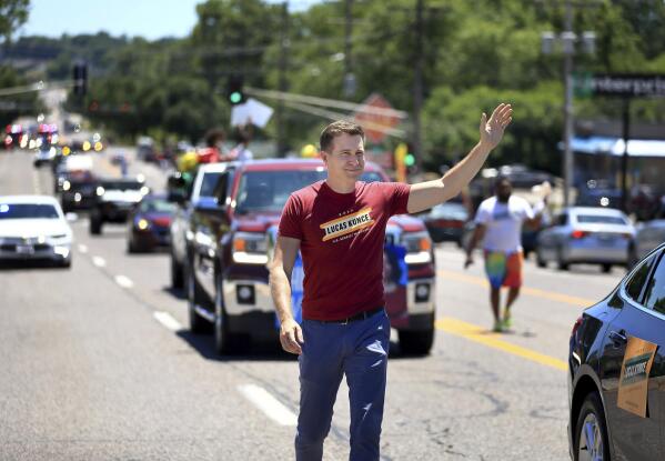 Lucas Kunce, a candidate who is seeking the Democratic nomination for the U.S. Senate, waves to people along West Florissant Ave.  during the Dellwood Juneteenth Parade and Celebration on Sunday, June 19, 2022, in Dellwood, Mo. Kunce brings a Marine swagger and a grassroots populism that appeals to some, particularly in outstate Missouri. He has raised more money than any other candidate — Democrat or Republican — in each of the last four quarters. (David Carson/St. Louis Post-Dispatch via AP)
